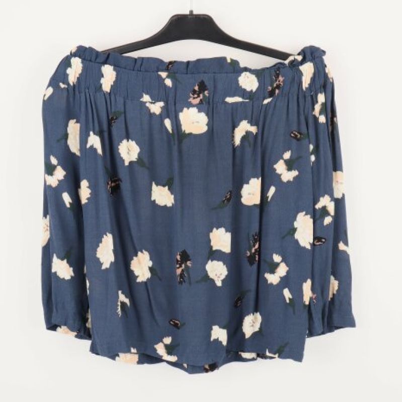Bakre vy av blå blommig kjol på galge